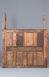 A carved oak shelf with pinnacles and stylised flowers and carved panels, 15th C. and later