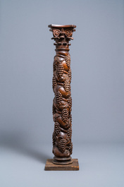 A carved walnut Ionic column with grapevines, 17th C.