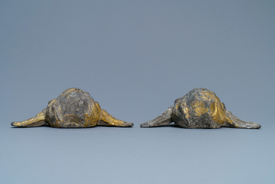 A pair of parcel-gilt lead winged cherub heads, 17th C.