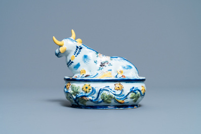 A polychrome Dutch Delft butter tub and cow cover, 18th C.