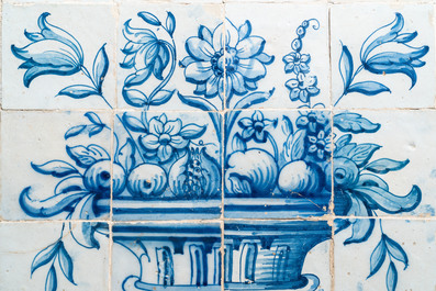 A blue and white Portuguese tile mural depicting an urn filled with flowers and fruits, 18th C.