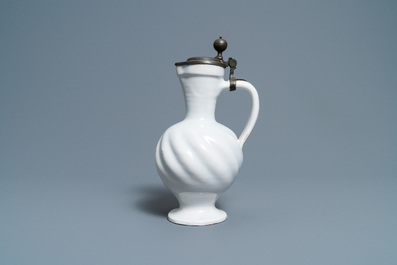 A gadrooned white Dutch Delftware jug with pewter cover, 17th C.