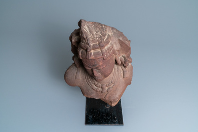 A fine red sandstone bust of a celestial nymph, Central India, 10/11th C.