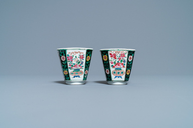 A pair of Chinese octagonal famille rose cups and saucers and a pair of verte biscuit dishes, Kangxi and Qianlong