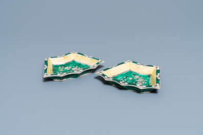 A pair of Chinese octagonal famille rose cups and saucers and a pair of verte biscuit dishes, Kangxi and Qianlong