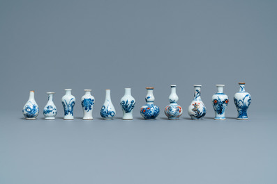 Six Chinese blue and white cups and saucers and eleven miniature vases, Kangxi