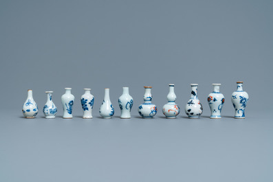 Six Chinese blue and white cups and saucers and eleven miniature vases, Kangxi