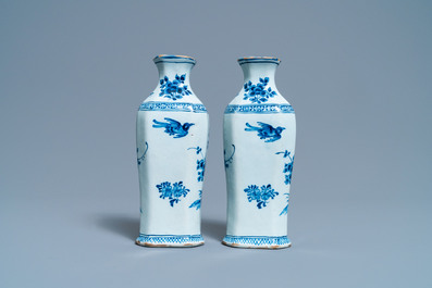 A pair of Dutch Delft blue and white vases and a 'peacock's tail' plate, 18th C.