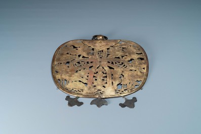 A large Sino-Tibetan reticulated gilt copper plaque with an engraved knot on a ground of lotus flowers, 17th C.