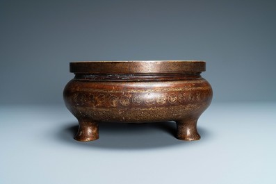 A Chinese parcel-gilt bronze tripod censer, Xuande merk, Qing