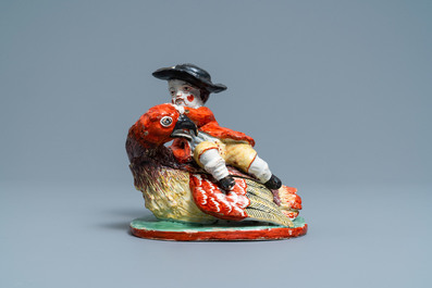 A polychrome Dutch Delft box and cover in the shape of a boy on a bird, 18th C.