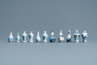 Six Chinese blue and white cups and saucers and eleven miniature vases, Kangxi