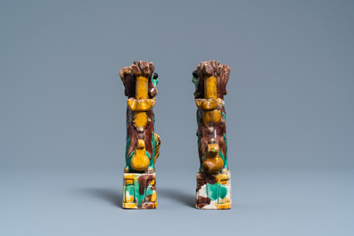 A pair of Chinese sancai models of dogs and a pair of 'Buddhist lions' joss stick holders, Kangxi