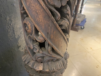 A pair of reticulated carved oak Corinthian columns with cherub heads and vines, 17th C.