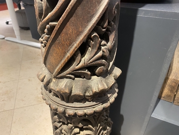 A pair of reticulated carved oak Corinthian columns with cherub heads and vines, 17th C.