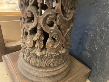 A pair of reticulated carved oak Corinthian columns with cherub heads and vines, 17th C.