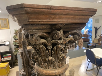 A pair of reticulated carved oak Corinthian columns with cherub heads and vines, 17th C.