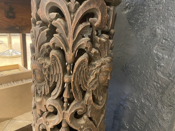 A pair of reticulated carved oak Corinthian columns with cherub heads and vines, 17th C.