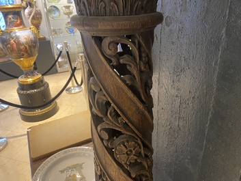 A pair of reticulated carved oak Corinthian columns with cherub heads and vines, 17th C.