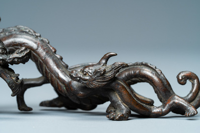 A rare Chinese bronze 'dragon' brush rest, Yuan/Ming