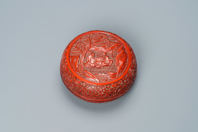 A Chinese round cinnabar lacquer box and cover with two scholars at a table, 18/19th C.