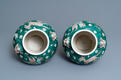 A pair of Chinese famille verte 'mythical animals' vases and covers, 19th C.