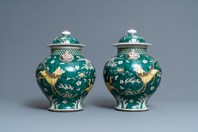 A pair of Chinese famille verte 'mythical animals' vases and covers, 19th C.