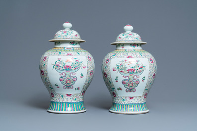 A pair of Chinese famille rose vases and covers, 19th C.