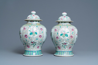 A pair of Chinese famille rose vases and covers, 19th C.