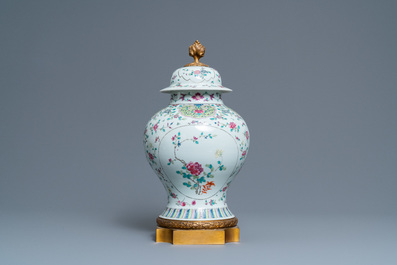 A Chinese famille rose vase and cover with gilt bronze mounts, 19th C.