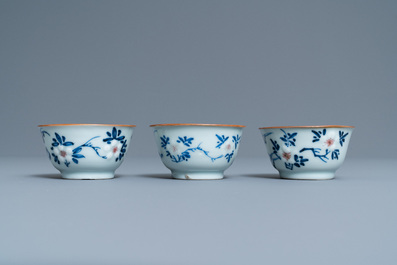 Three Chinese blue, white and copper-red cups and saucers, Kangxi