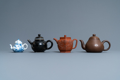 Four Chinese Yixing stoneware, blue and white and monochrome black porcelain teapots, Kangxi and later