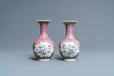 A pair of Chinese famille rose bottle vases with floral design, 19/20th C.