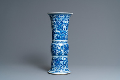 A Chinese blue and white 'gu' vase with floral and lanscape panels, Kangxi