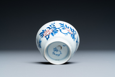 A Chinese blue, white and copper-red cup and saucer, Kangxi