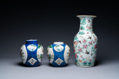 A Chinese famille rose vase and a pair of famille verte powder blue-ground jars, 19th C.