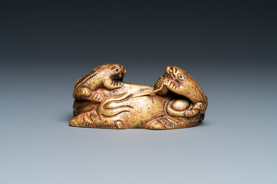 Un poids de rouleau en bronze dor&eacute; en forme de lion et deux lionceaux, Qing