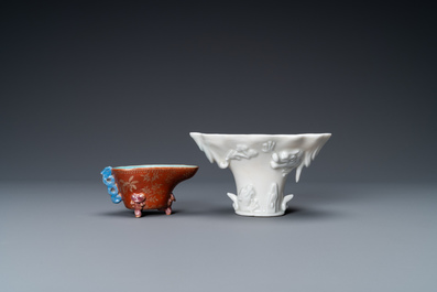 A Chinese blanc de Chine libation cup and a gilt-decorated coral-ground one, Kangxi and 19th C.