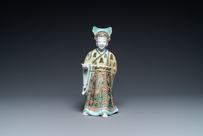 A Chinese famille verte figure on wooden stand, Kangxi