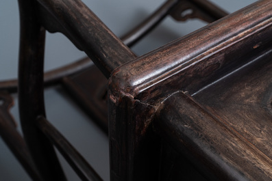 A pair of Chinese carved wooden chairs with wicker seats, 19th C.