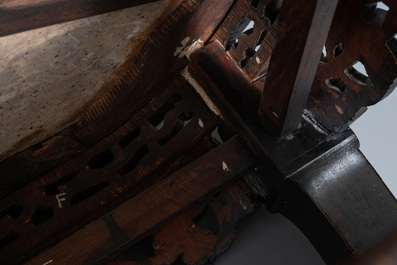 A Chinese carved wooden marble top stand, 19th C.