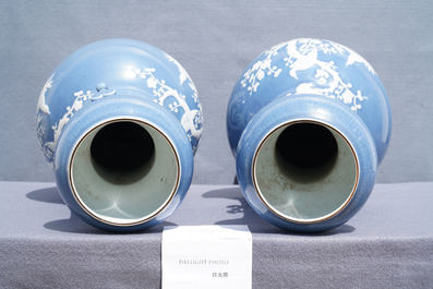 A pair of Chinese white slip-decorated blue-ground vases, 19th C.