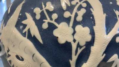 A pair of Chinese white slip-decorated blue-ground vases, 19th C.