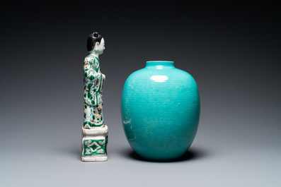 A Chinese verte biscuit figure, a green 'lotus' jar and a figurative blue and white plate, Kangxi and later