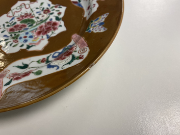 A pair of Chinese famille rose plates, Qianlong, and a blue and white plate, Kangxi mark and of the period