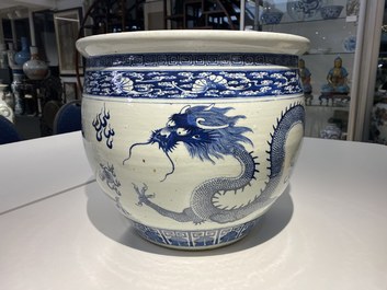 A Chinese blue and white 'dragons' fish bowl, Qianlong/Jiaqing