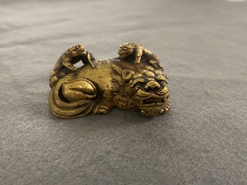A Chinese gilt bronze 'lion with cubs' scroll weight, Qing