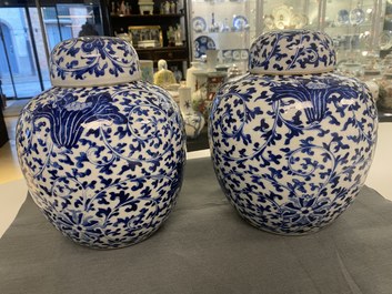 Three Chinese blue and white jars and covers with floral scrolls, 19th C.