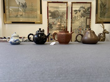 Four Chinese Yixing stoneware, blue and white and monochrome black porcelain teapots, Kangxi and later