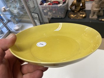 A Chinese monochrome yellow-glazed plate, Kangxi mark and of the period